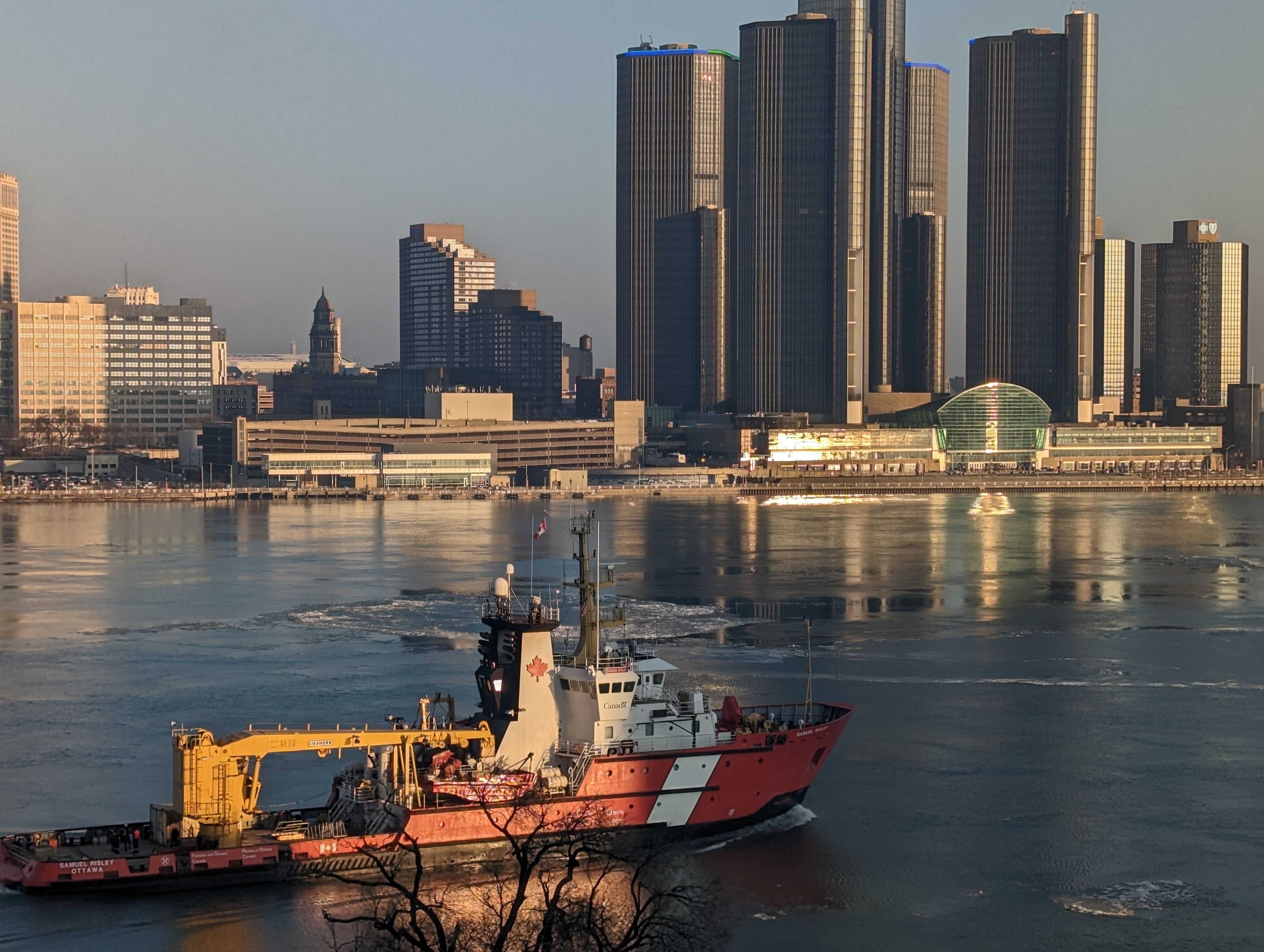 ship sailing in front of city skyline