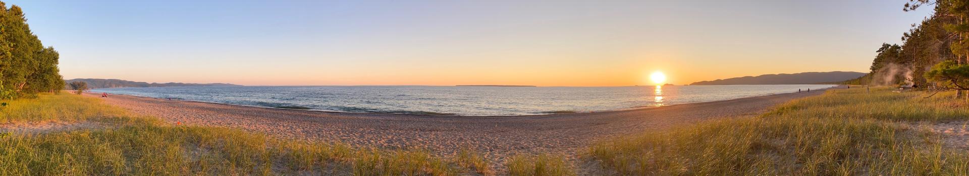 Sun setting over horizon