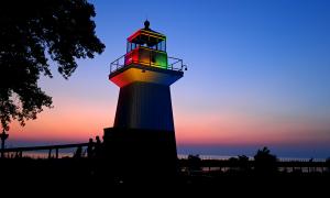 The Oak Orchard Lighthouse Light Show on Lake Ontario is complemented by a sunset in Orleans County, NY</br>Point Breeze, New York </br> Recreation. Lynne Menz.