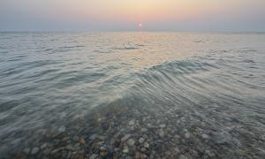 Sunset whilst rock hounding at the Torch Bay Nature Reserve. July 2025. Torch Lake, Michigan. Recreation. Joe Smith.