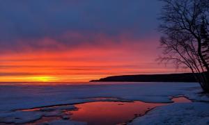 A sunset over the melting lake. Sault Ste Marie, Ontario. Great Lakes Water in Action. Victoria Redegeld
