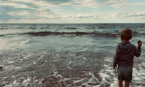 Child playing in the waves of Lake Erie. Dunkirk, New York. Great Lakes Water in Action. Cassandra Pinkoski