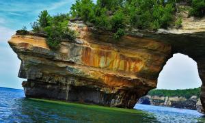 Kayakers beneath Lake Superior's Painted Cliffs. Munising, Michigan. Recreation. Phanikumar Mantha