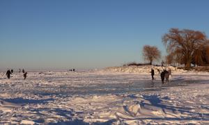 People walking and playing on the ice of Lake Erie, 2026. Cleveland, Ohio. Great Lakes Water in Action. Lorin Hancock